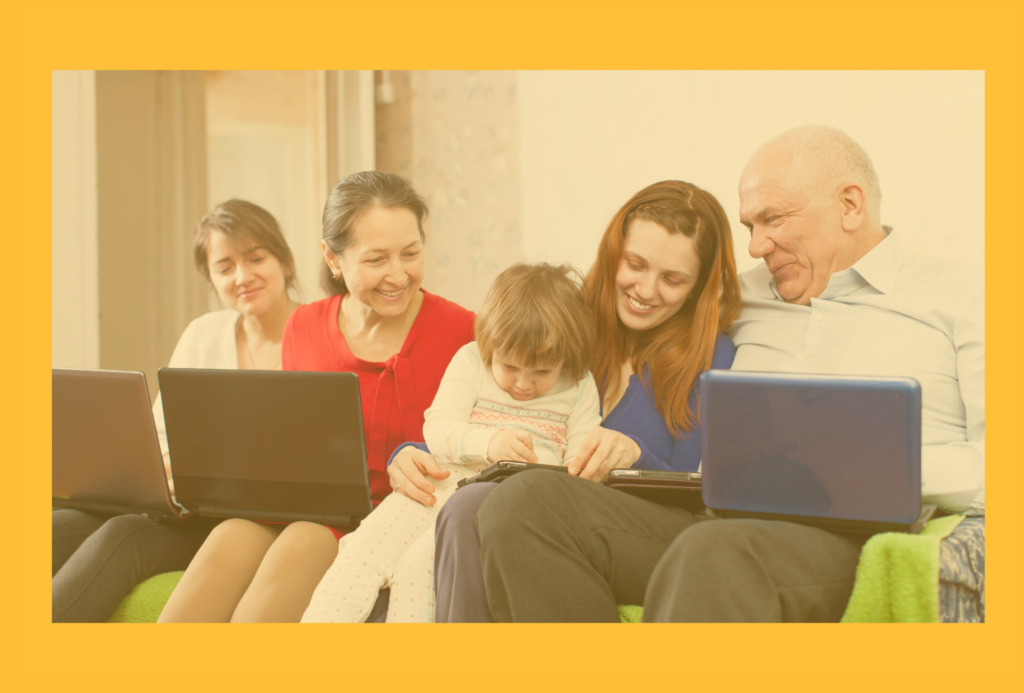 Multigenerational family sitting together enjoying technology devices. 