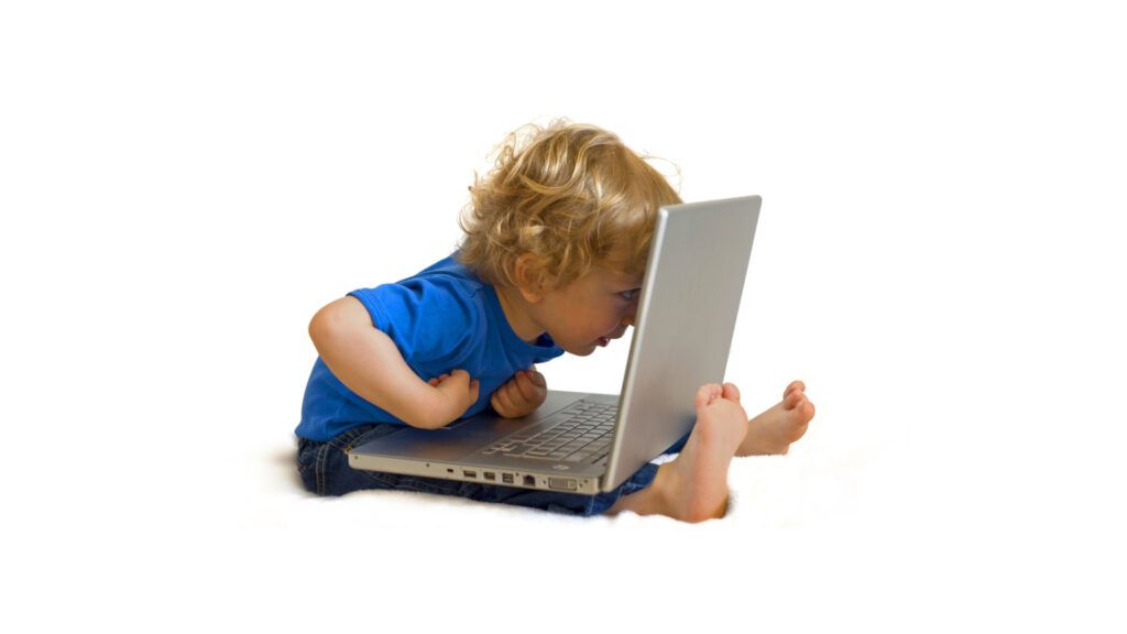 Toddler with eyes very close to laptop screen.